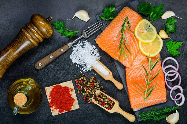 Salmon Fish Fillet with food seasoning, spices and cooking ingredients and herbs