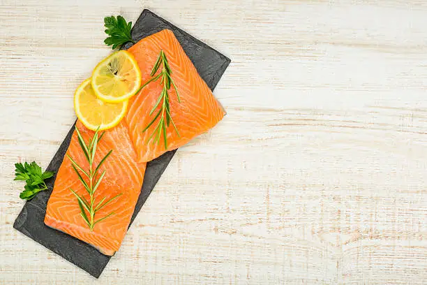Salmon Fish Fillet with lemon and Cooking herbs on Copy space area