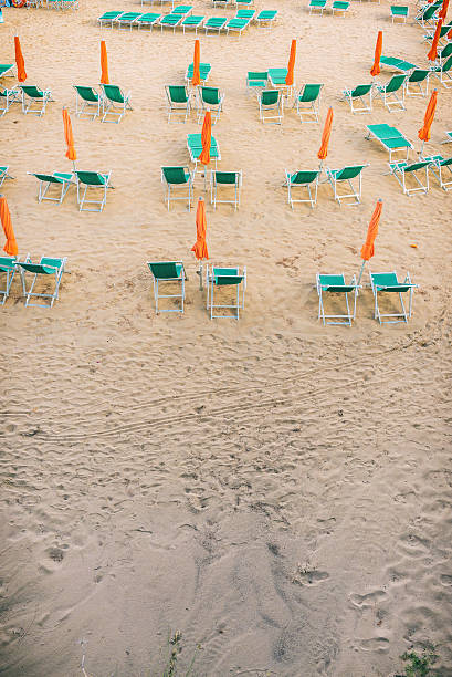 istock Closed umbrellas and sunbeds on a September beach 608568102