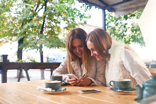 istock Girls reading message on the phone 608569014