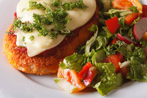 istock Chicken Parmigiana and fresh salad macro. Horizontal 608573248
