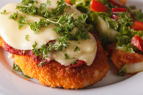 chicken parmigiana and vegetable salad macro. horizontal - parmesan cheese chicken veal salad imagens e fotografias de stock