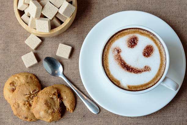 istock Top view white cup of latte art happy smile face 608574220