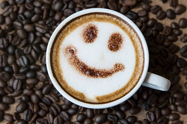 istock Top view white cup of latte art happy smile face 608574952