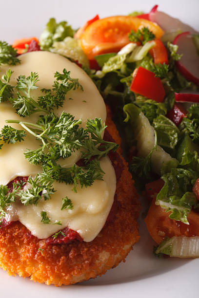 chicken parmigiana and vegetable salad macro. vertical - parmesan cheese chicken veal salad imagens e fotografias de stock