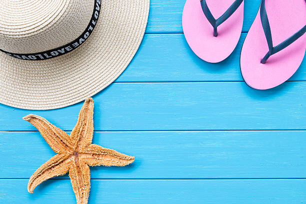 istock Straw hat and slippers on wood 608578680