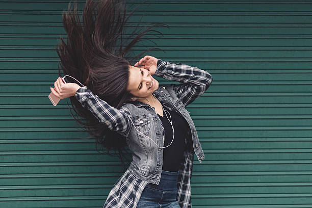 istock Girl shaking head to music 608578864