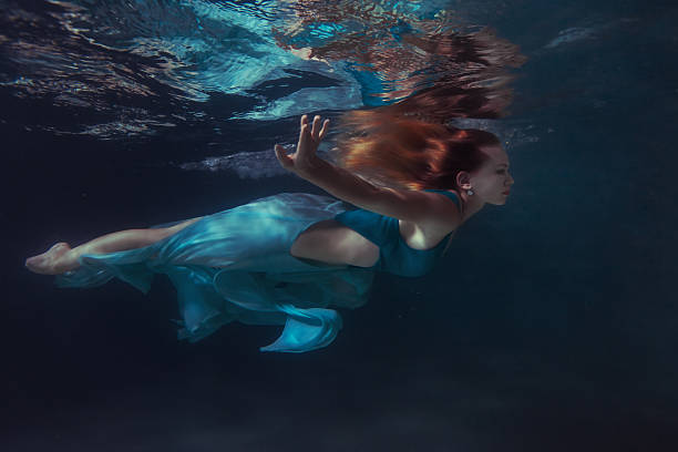 istock Woman in a dress floats. 608578882