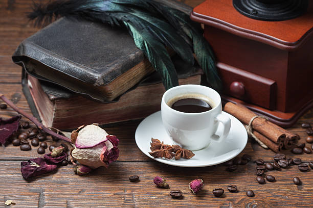 istock Cup of coffee, dry rose and grinder 608580676