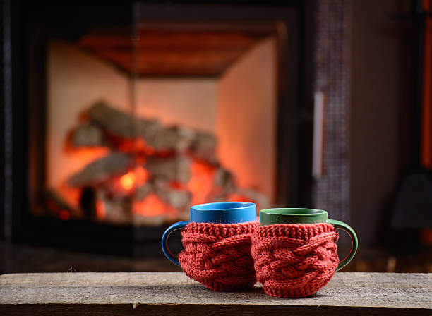 istock two cups near the fireplace on vintage wooden table 608580896