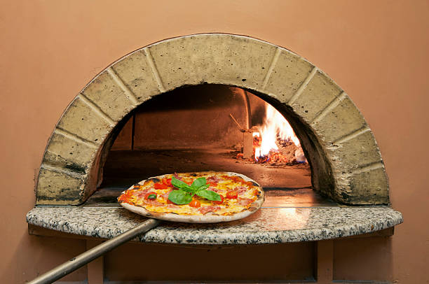 istock wood oven with freshly baked pizza 608591034