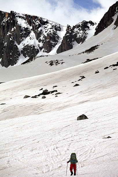 istock Hiker in snowy mountain at nice spring day 608594450