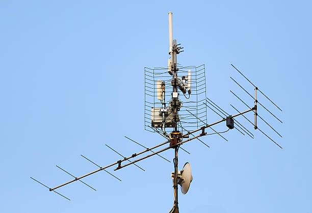istock antenna and wi-fi transmitter on the roof 608597118