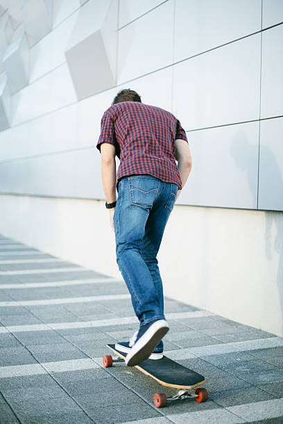 istock Rear view of skateboarder in ride 608597380
