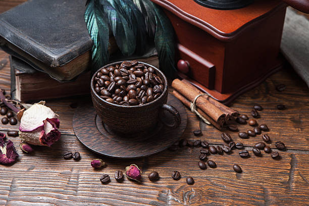 istock Cup of coffee, dry rose and grinder 608599048