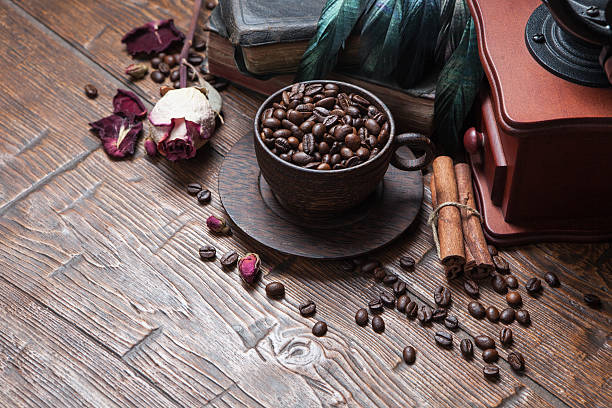 istock Cup of coffee, dry rose and grinder 608600416