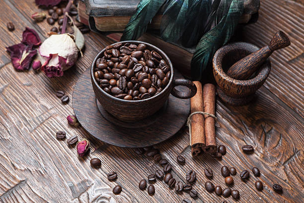 istock Cup of coffee, dry rose and grinder 608601584