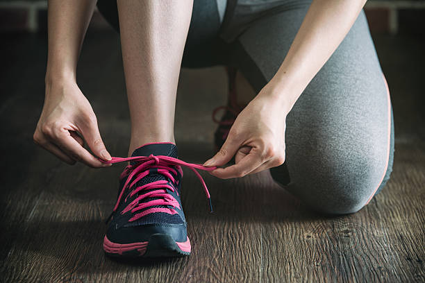 istock knee down with tie sneakers shoestring before fitness exercise 608604590