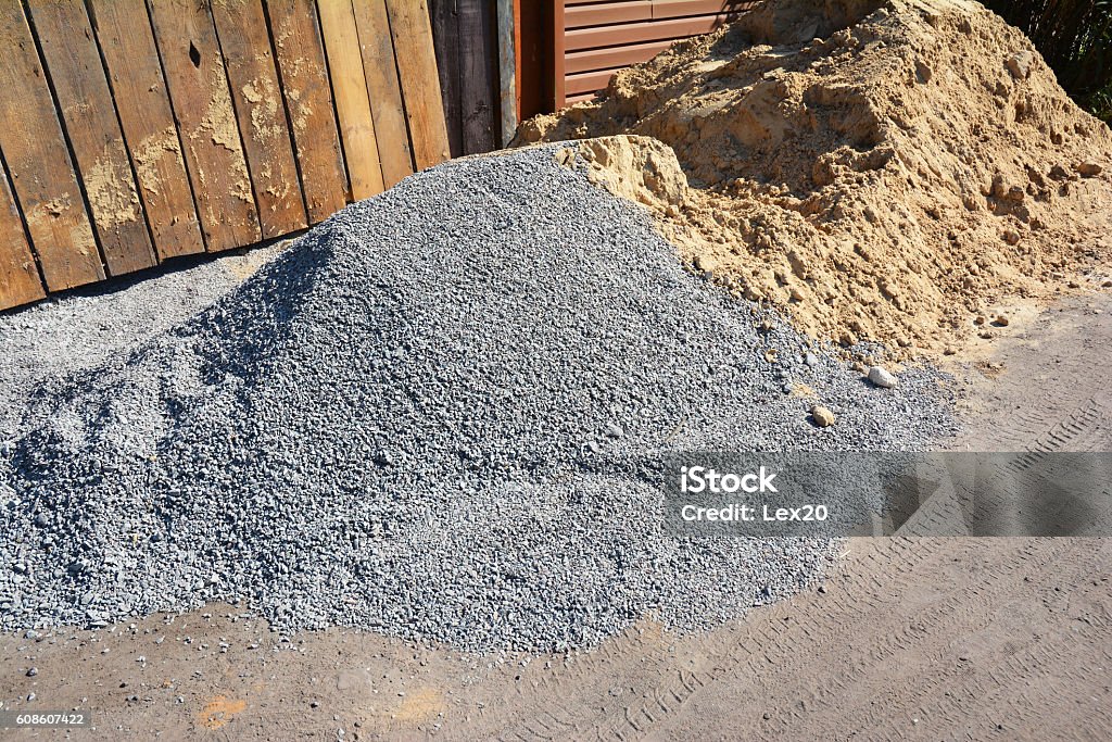 Two piles of gravel and sand at industrial site. Two piles of gravel and sand at industrial site. Building materials on the construction site. Sand Stock Photo