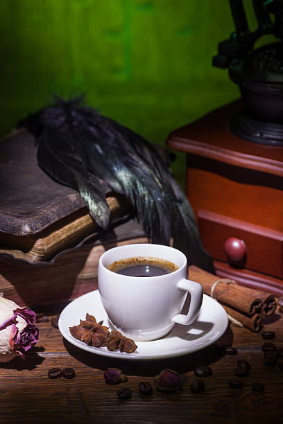 istock Cup of coffee, dry rose and grinder 608609036