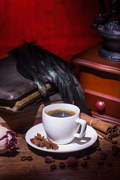 istock Cup of coffee, dry rose and grinder 608609370