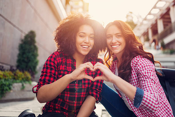 Girls making heart with hands