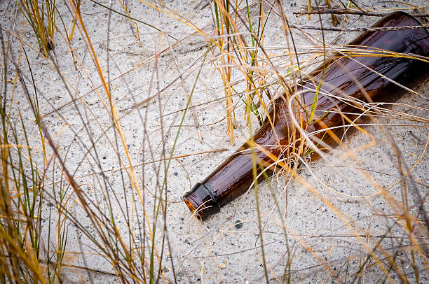 istock Glass Bottle on the Beach 608613070
