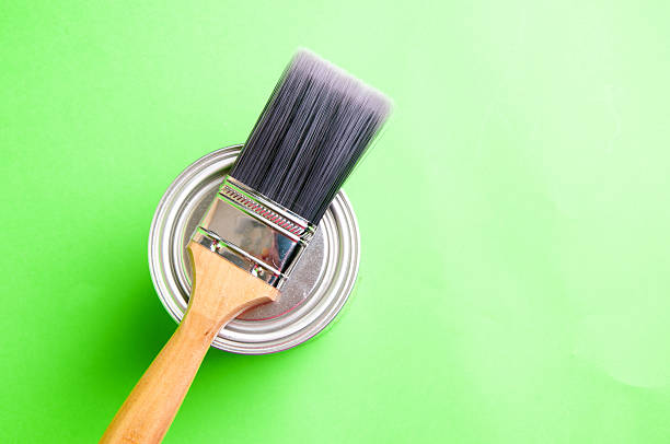 istock Brush and paint on a green background 608615408