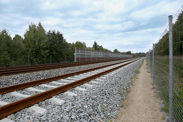 istock Railway with noise damping wall 608616060