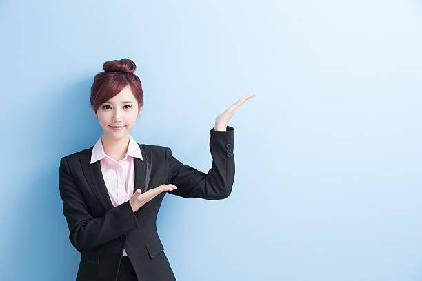 istock business woman show something 608621680