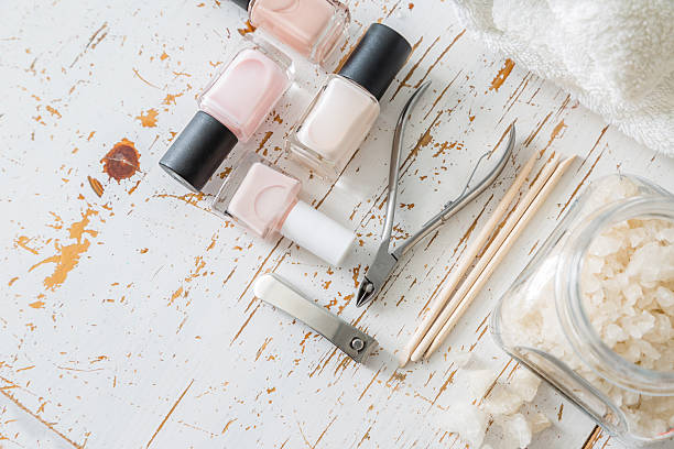 istock Selection of manicure tools on white wood background 608621686