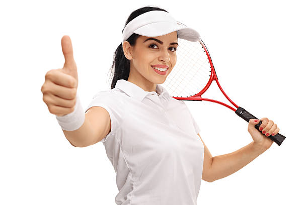 Female tennis player giving a thumb up and holding a racket isolated on white background