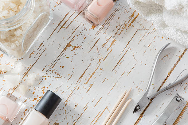 istock Selection of manicure tools on white wood background 608622442