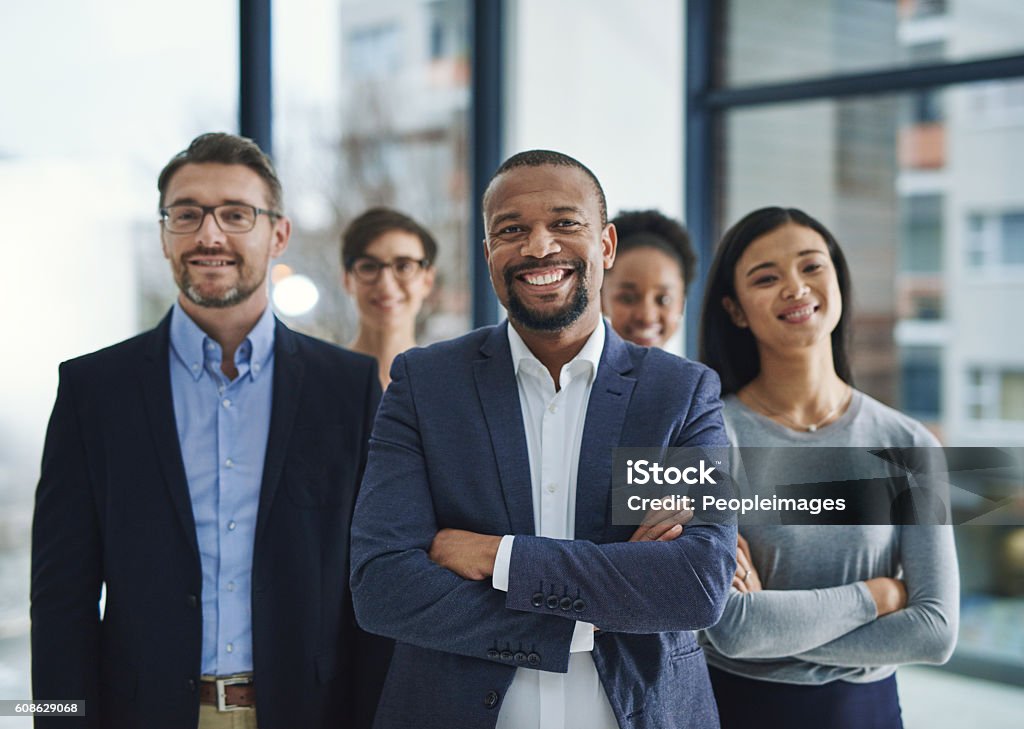 We pride ourselves on our professionalism Portrait of a diverse team of professionals standing in the office Organized Group Photo Stock Photo