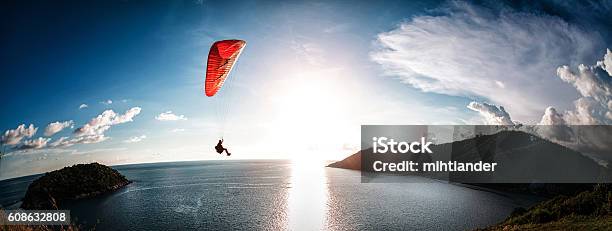 Paraglider Flying Over The Water Stock Photo - Download Image Now - Paragliding, Adventure, Blue