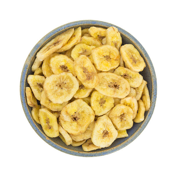 istock Dried bananas in an old bowl on white background 608632964