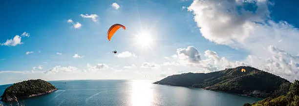 Photo of Paraglider flying over the water