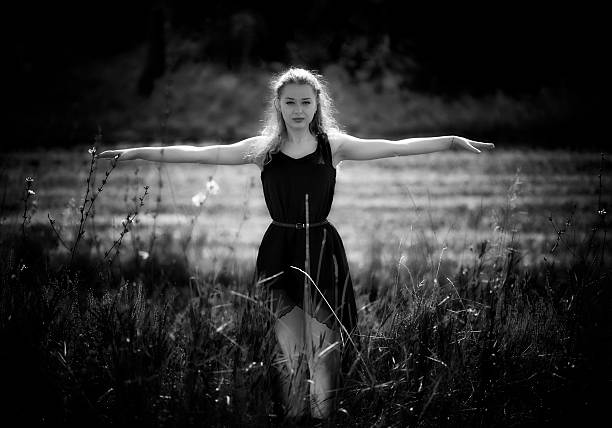 istock Girl in a black opened her arms to the side 608634800