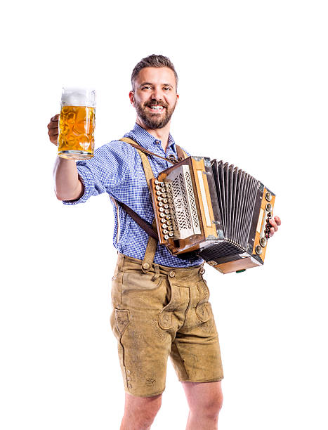 istock Man in bavarian clothes holding beer, playing accordion. October 608635052