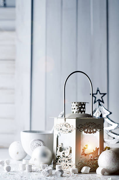 istock Burning lantern and christmas decoration on white background 608635090