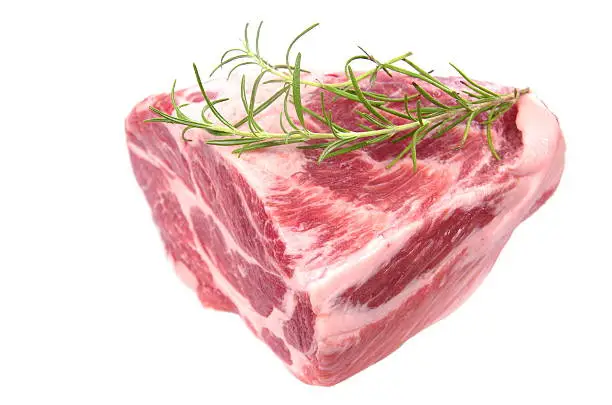 raw chuck steak with rosemary on white background