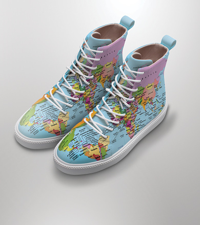 A pair of trainers overpainted with a map of the world