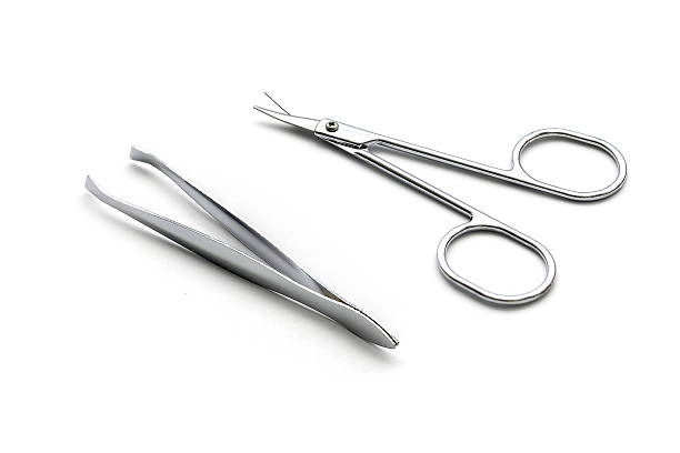 istock scissor and tweezers isolated on white background 608640362