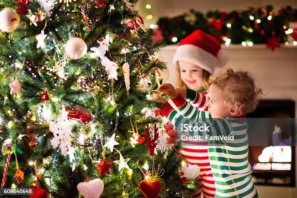 Kids Decorating Christmas Tree In Beautiful Living Room Stock Photo - Download Image Now