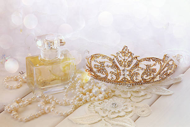 istock White pearls necklace, diamond tiara and perfume bottle 608641100