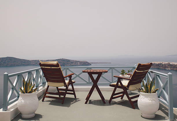 istock Chairs And Table In Balcony Against Clear Sky On Sunny Day 608954575