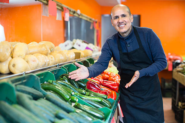 istock Mature man selling veggies 609029648