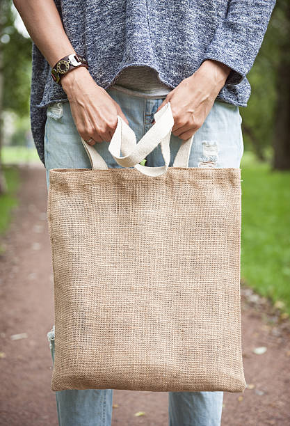 istock Woman holding empty canvas bag. Template mock up 609029690
