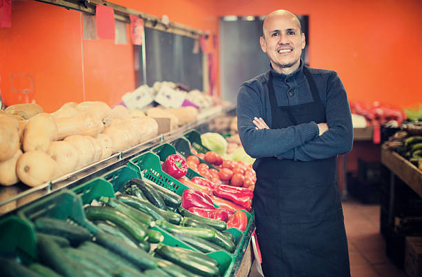 istock Mature man selling veggies 609029722
