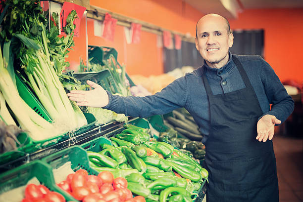 istock Mature man selling veggies 609029868